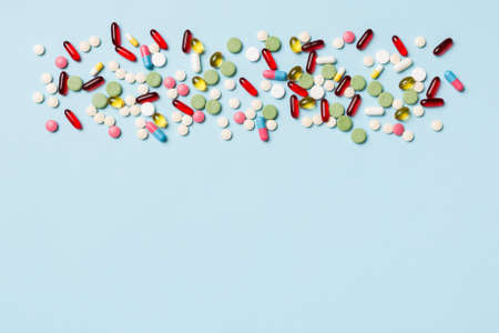 Protective face masks or surgical masks, medicine pills and thermometer on table background....