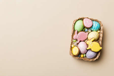 holiday preparation Multi colors Easter eggs with cookies on colored background . Pastel color Easter eggs. holiday concept with copy space.の写真素材