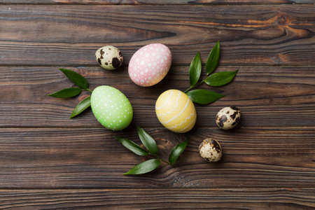 Colorful Easter eggs with spring flower leaf isolated over white background. Colored Egg Holiday border.の写真素材