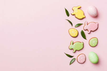 holiday preparation Multi colors Easter eggs with cookies on colored background . Pastel color Easter eggs. holiday concept with copy space.の写真素材