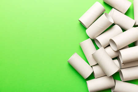 Flat lay composition with empty toilet paper rolls and space for text on color background. Recyclable paper tube with metal plug end made of kraft paper or cardboard.の写真素材