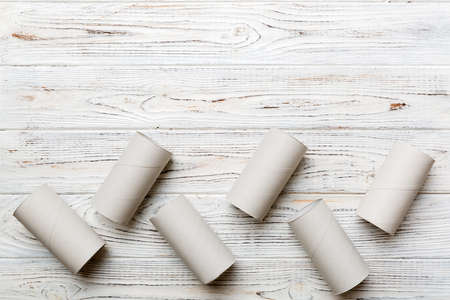 Flat lay composition with empty toilet paper rolls and space for text on color background. Recyclable paper tube with metal plug end made of kraft paper or cardboard.の写真素材
