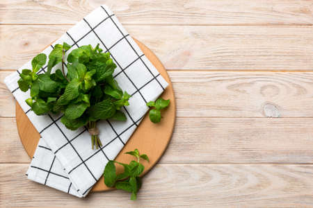 Fresh mint on Cutting board table, top view. Flat lay Space for text.