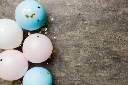 Background with fastive air balloons of round shape and confetti, multicolored top view. birthday party background.の写真素材