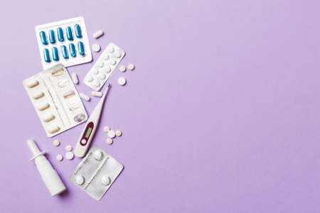 Protective face masks or surgical masks, medicine pills and thermometer on table background....