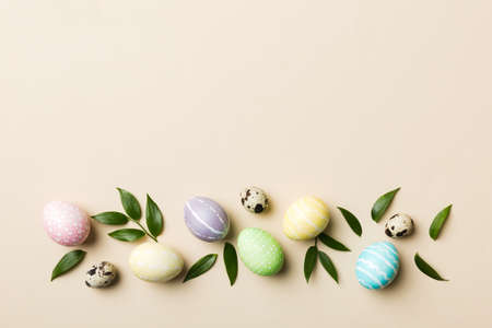 Colorful Easter eggs with spring flower leaf isolated over white background. Colored Egg Holiday border.の写真素材