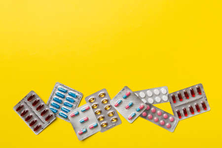 Protective face masks or surgical masks, medicine pills and thermometer on table background. coronavirus disease. Corona virus concept. Space for text.の写真素材