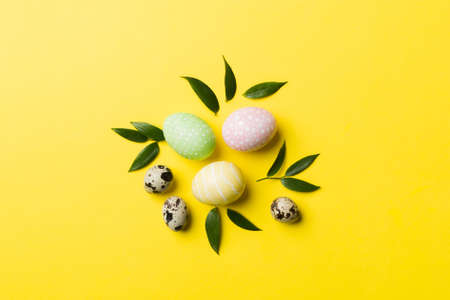 Colorful Easter eggs with spring flower leaf isolated over white background. Colored Egg Holiday border.の写真素材