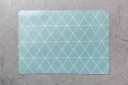 Top view of gray tablecloth for food on cement background. Empty space for your design.