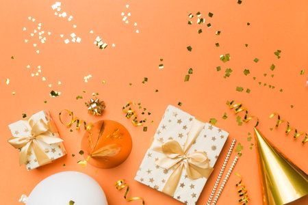 Holiday background with colorful balloon, gift and confetti. Flat lay style. Birthday or party greeting card with copy space.の写真素材