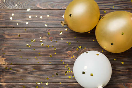 Background with fastive air balloons of round shape and confetti, multicolored top view. birthday party background.の写真素材