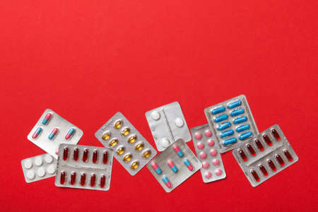 Protective face masks or surgical masks, medicine pills and thermometer on table background....