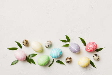 Colorful Easter eggs with spring flower leaf isolated over white background. Colored Egg Holiday...