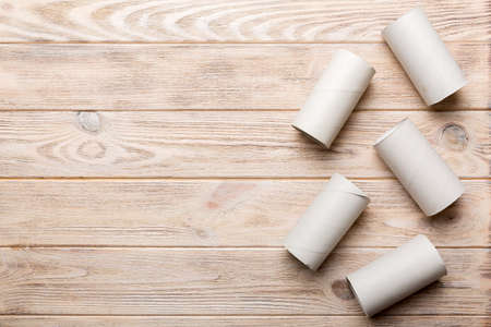Flat lay composition with empty toilet paper rolls and space for text on wooden background....