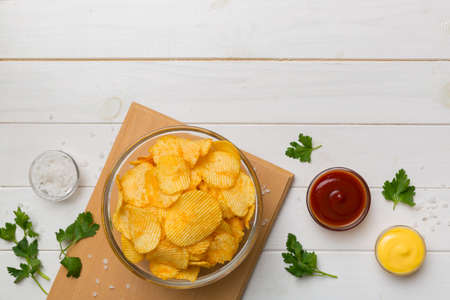 Top view chips with sauce in bowl on wooden background, top view with copy space.の写真素材