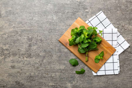 Fresh mint on Cutting board table, top view. Flat lay Space for text.の写真素材
