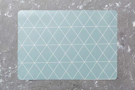 Top view of gray tablecloth for food on cement background. Empty space for your design.