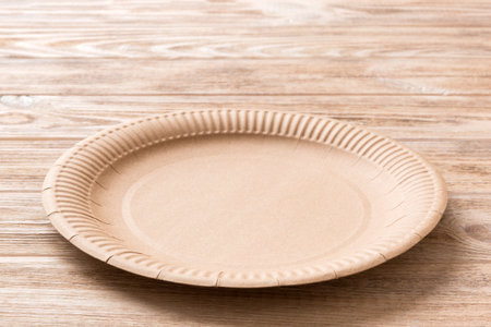 Perspective view of eco paper plate on wooden background. Empty space for your design.の写真素材