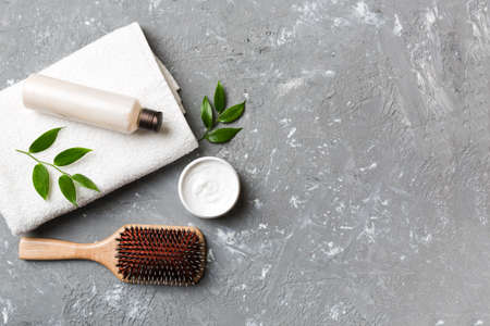 cosmetic for hair care, cream and towel on a colored background top view. flat lay.の写真素材