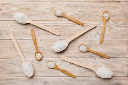 salt on wooden spoon on wood background. Spoons with different salt.の写真素材