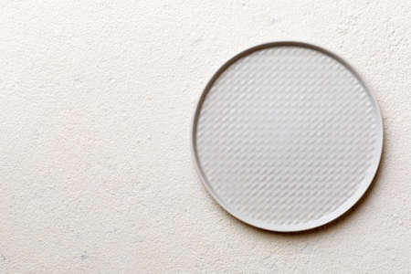 Top view of empty light plate on cement background. Empty space for your design.の写真素材