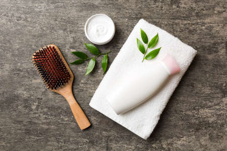 cosmetic for hair care, cream and towel on a colored background top view. flat lay.