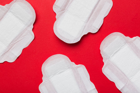 Women hygiene products or sanitary pad on colored background. pastel color. closeup. Empty place for text. Female daily hygiene.の写真素材