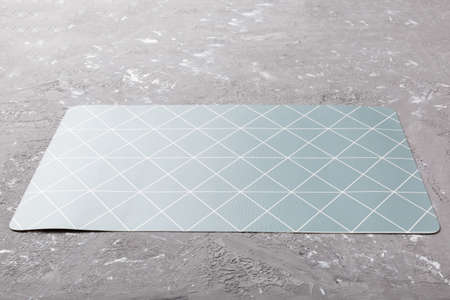 Perspective view of gray tablecloth for food on cement background. Empty space for your design.