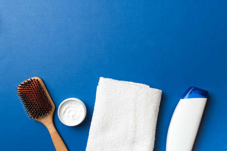 cosmetic for hair care, cream and towel on a colored background top view. flat lay.の写真素材