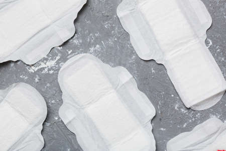 Women hygiene products or sanitary pad on colored background. pastel color. closeup. Empty place for text. Female daily hygiene.の写真素材