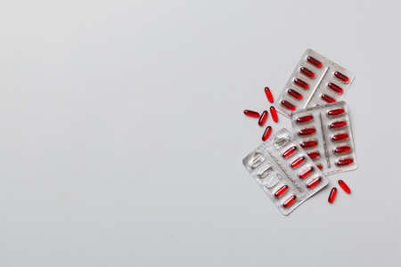 Protective face masks or surgical masks, medicine pills and thermometer on table background....