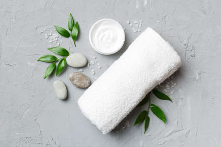 Coconut with jars of coconut oil and cosmetic cream on colored background. top view. Free space for your text. Natural spa coconut cosmetics and organic treatment concept Coconut Spa composition.の写真素材