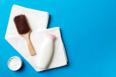cosmetic for hair care, cream and towel on a colored background top view. flat lay.の写真素材