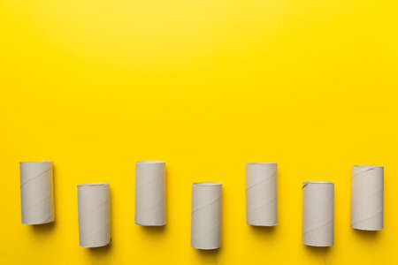 Flat lay composition with empty toilet paper rolls and space for text on color background. Recyclable paper tube with metal plug end made of kraft paper or cardboard.の写真素材