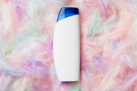 Spa cosmetic product, cream bottle, branding mock up, top view with feathers background. flat lay.の写真素材