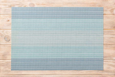 Top view of blue tablecloth for food on wooden background. Empty space for your design.の写真素材