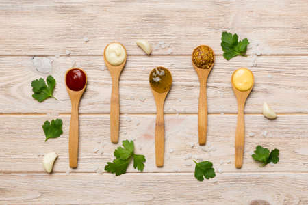 Different sauces in spoons on table background, flat lay top view.の写真素材