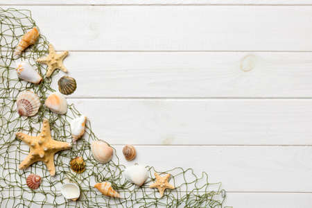 Summer time concept Flat lay composition with beautiful starfish and sea shells on colored table,...