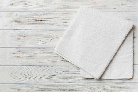 Top view of white towels with copy space on colored background.