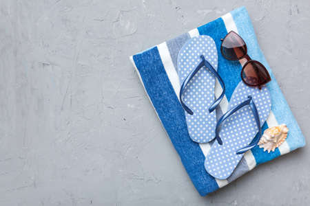 Summer travel concept. Flip flops, sunglasses and starfish on white. Top view on colored background.の写真素材