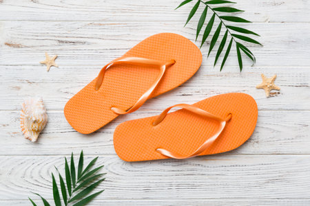 Flat lay composition with flip flops and seashell on colored background. Space for text view.の写真素材