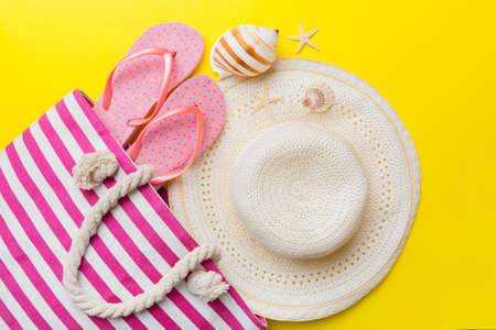 beach accessories flat lay top view on colored background Summer travel concept. Bag with starfish and sea shell. top view.の写真素材