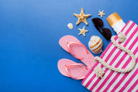 beach accessories flat lay top view on colored background Summer travel concept. Bag with starfish and sea shell. top view.の写真素材