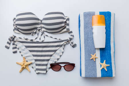 Woman swimwear and beach accessories flat lay top view on colored background Summer travel concept....