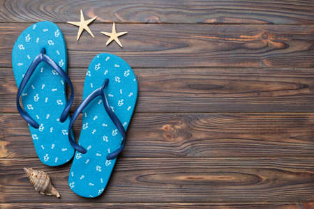 Flat lay composition with flip flops and seashell on colored background. Space for text view.の写真素材