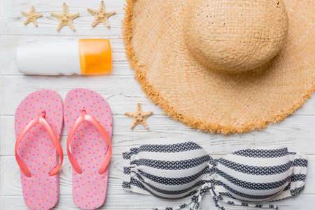 Woman swimwear and beach accessories flat lay top view on colored background Summer travel concept....