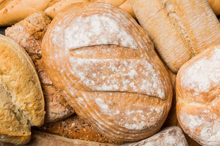 Homemade natural breads. Different kinds of fresh bread as background, top view with copy space.