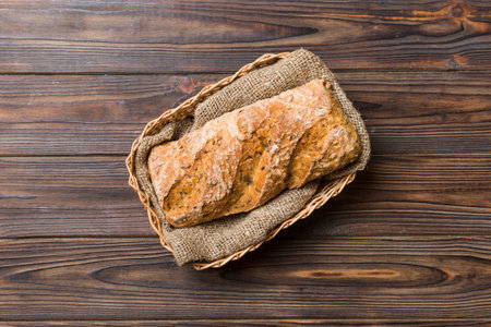 Freshly baked bread on basket against natural background. top view bread copy space.