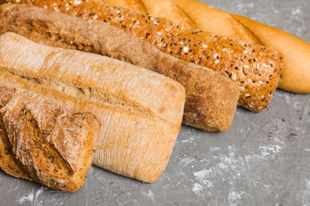 Homemade natural breads. Different kinds of fresh bread as background, perspective view with copy...