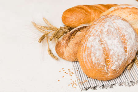 Homemade natural breads. Different kinds of fresh bread as background, perspective view with copy...